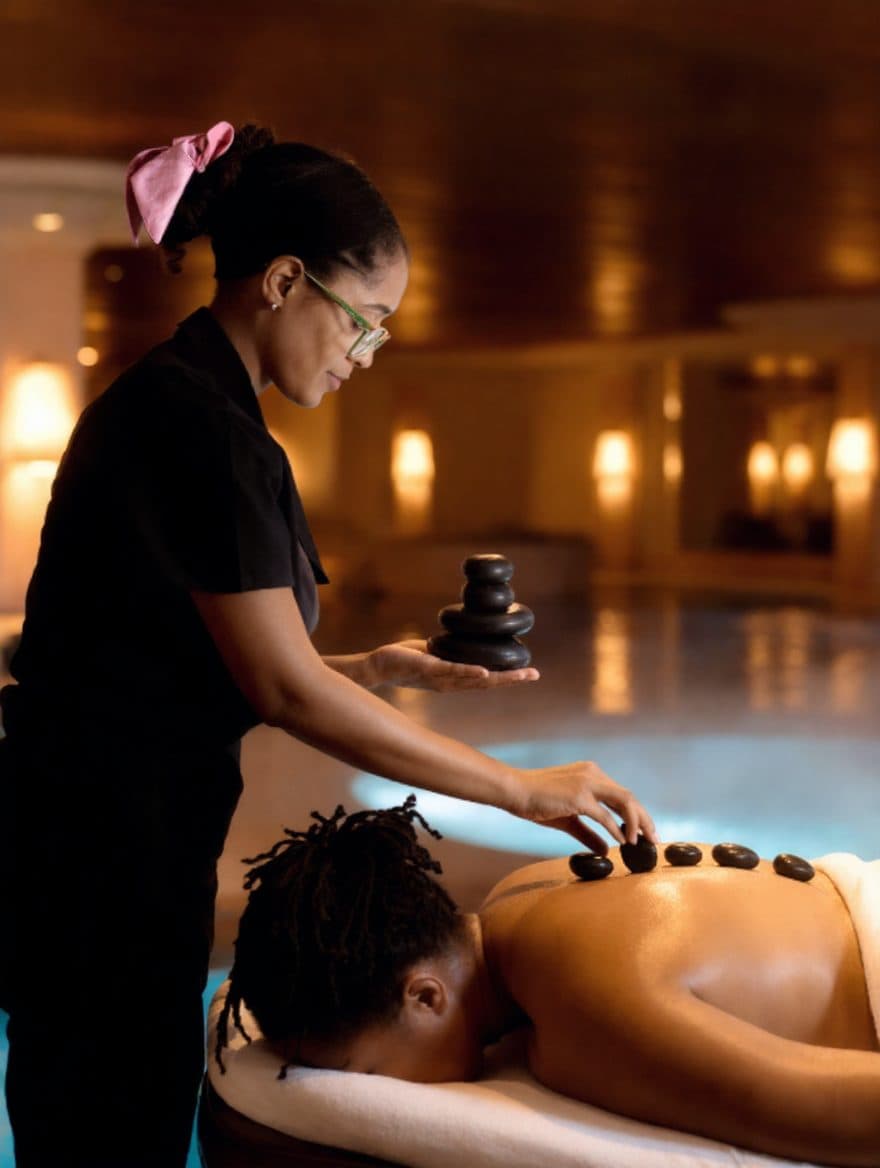 Hot stone massage in a warmly lit spa, hot stone massage in Barbados